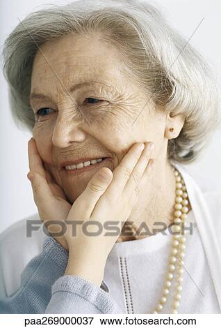 Girl holding grandmother's face View Large Photo Image Stock Photo - Girl holding grandmother's face. Fotosearch