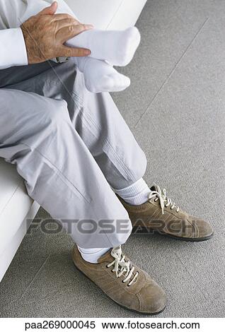 Grandfather sitting with hands on boy's feet View Large Photo Image Stock Photography - Grandfather sitting with hands on boy's feet. Fotosearch