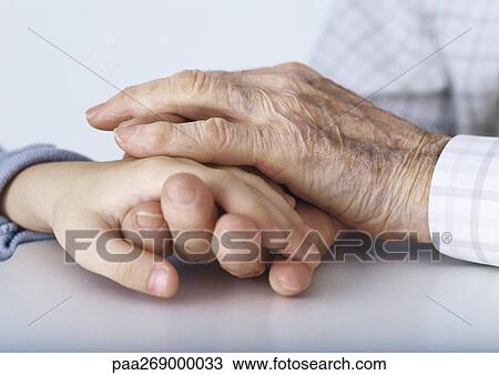 Grandfather's hands clasping girl's hand View Large Photo Image Stock Image - Grandfather's hands clasping girl's hand. Fotosearch