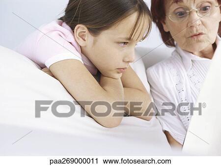 Grandmother and girl reading from book View Large Photo Image Stock Image - Grandmother and girl reading from book. Fotosearch