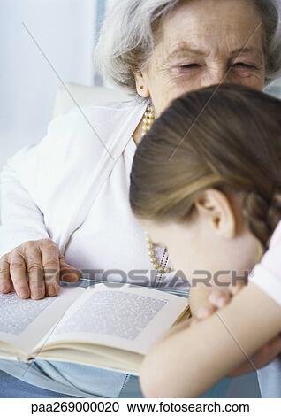 Grandmother and girl with book View Large Photo Image Stock Image - Grandmother and girl with book. Fotosearch