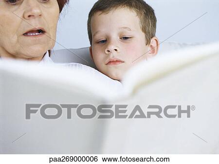 Grandmother reading book to boy View Large Photo Image Stock Photograph - Grandmother reading book to boy. Fotosearch