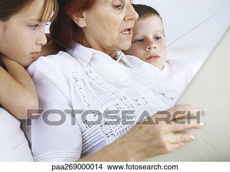 Grandmother reading to boy and girl View Large Photo Image Picture - Grandmother reading to boy and girl. Fotosearch