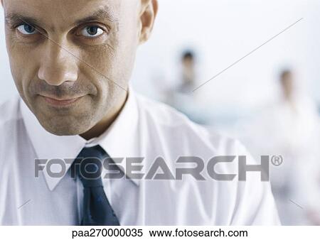 Businessman looking at camera View Large Photo Image Stock Photography - Businessman looking at camera. Fotosearch