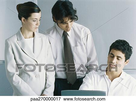 Businesspeople discussing in office View Large Photo Image Stock Photo - Businesspeople discussing in office. Fotosearch