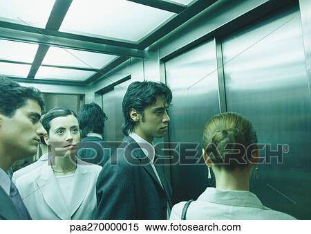 Businesspeople in elevator, head and shoulders View Large Photo Image Stock Photography - Businesspeople in elevator, head and shoulders. Fotosearch