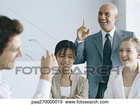 Businesspeople interacting and smiling View Large Photo Image Stock Photo - Businesspeople interacting and smiling. Fotosearch