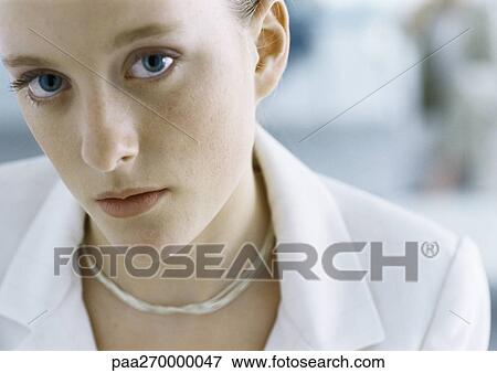 Stock Photo - Woman looking at camera, close-up. Fotosearch