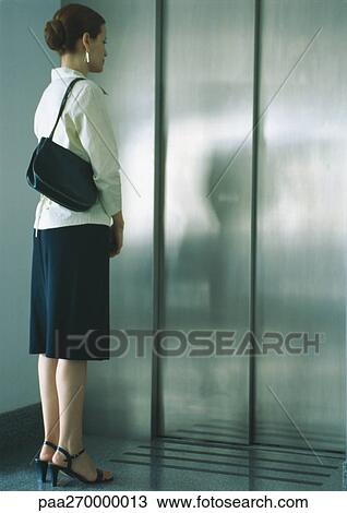 Woman waiting for elevator, full length View Large Photo Image Stock Image - Woman waiting for elevator, full length. Fotosearch
