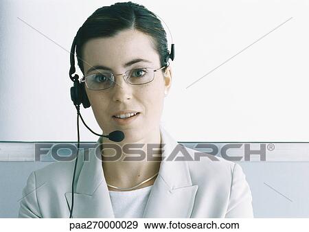 Woman wearing headset, portrait View Large Photo Image Stock Photo - Woman wearing headset, portrait. Fotosearch