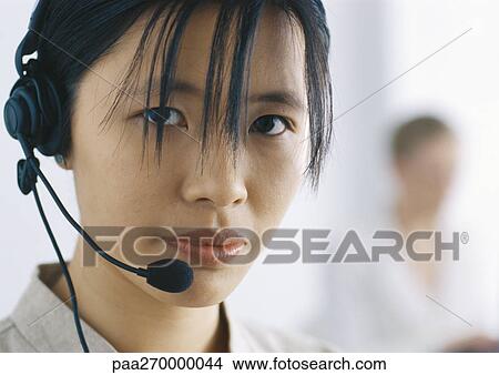 Woman with headset looking at camera View Large Photo Image Picture - Woman with headset looking at camera. Fotosearch