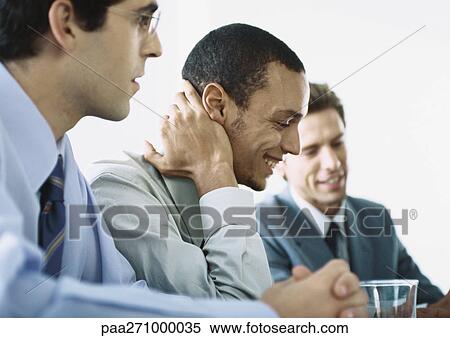 Businessmen sitting together in meeting View Large Photo Image Stock Photography - Businessmen sitting together in meeting. Fotosearch