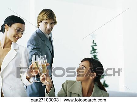 Stock Image - Businesspeople clinking glasses. Fotosearch