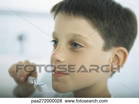 Stock Photo - Boy brushing teeth, close-up. Fotosearch