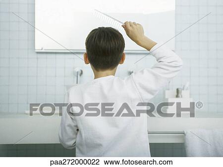 Boy combing hair in mirror, rear view View Large Photo Image Stock Image - Boy combing hair in mirror, rear view. Fotosearch