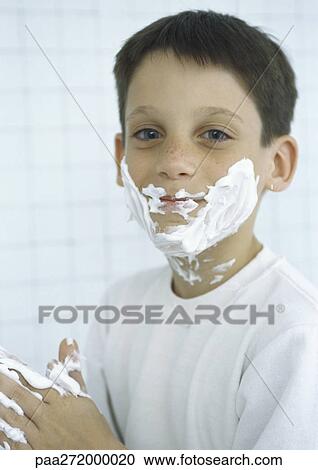 Stock Image - Boy with shaving cream on face and hands. Fotosearch