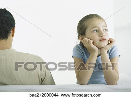 Girl holding head, leaning on elbows next to man, rear view View Large Photo Image Picture - Girl holding head, leaning on elbows next to man, rear view. Fotosearch