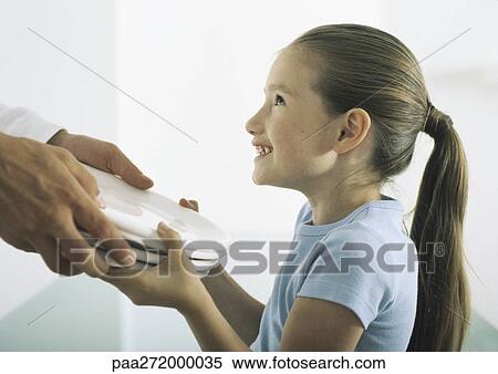 Girl smiling, taking plates from man's hands View Large Photo Image Stock Photography - Girl smiling, taking plates from man's hands. Fotosearch