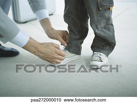 Man tying boys shoes, low section View Large Photo Image Stock Image - Man tying boys shoes, low section. Fotosearch