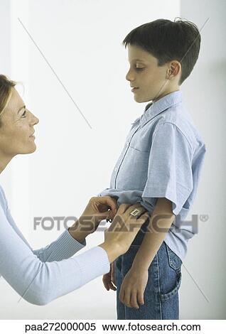 Mother dressing boy View Large Photo Image Stock Photography - Mother dressing boy. Fotosearch