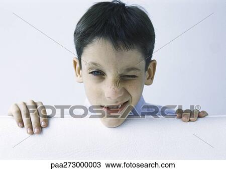 Stock Image - Boy making face, portrait. Fotosearch