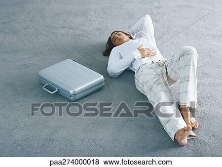 Man lying on carpet next to briefcase View Large Photo Image Stock Photo - Man lying on carpet next to briefcase. Fotosearch