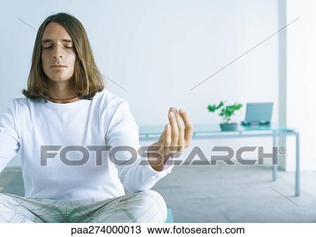 Man sitting in lotus position View Large Photo Image Stock Image - Man sitting in lotus position. Fotosearch