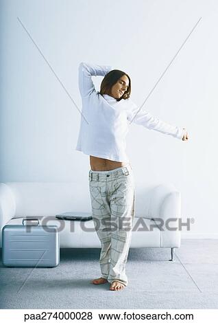 Man stretching in front of sofa and briefcase View Large Photo Image Stock Photo - Man stretching in front of sofa and briefcase. Fotosearch