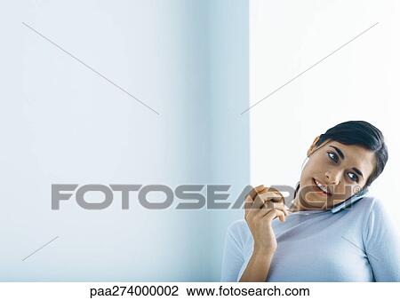 Woman holding apple and talking on phone View Large Photo Image Stock Image - Woman holding apple and talking on phone. Fotosearch