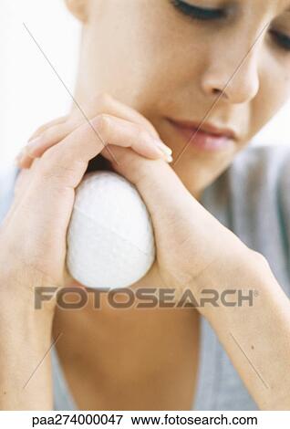 Woman holding stress ball between palms, close-up View Large Photo Image Stock Photo - Woman holding stress ball between palms, close-up. Fotosearch