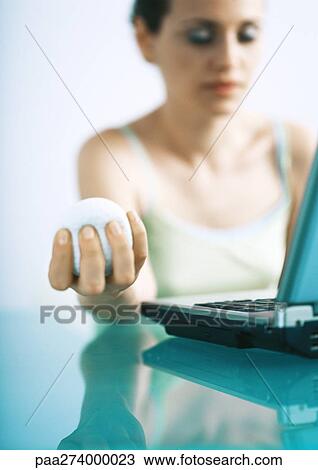 Woman holding stress ball, eyes closed View Large Photo Image Stock Image - Woman holding stress ball, eyes closed. Fotosearch