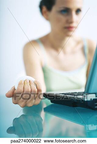 Stock Image - Woman holding stress ball. Fotosearch