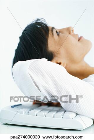 Woman leaning head back on computer keyboard, side view View Large Photo Image Stock Photo - Woman leaning head back on computer keyboard, side view. Fotosearch