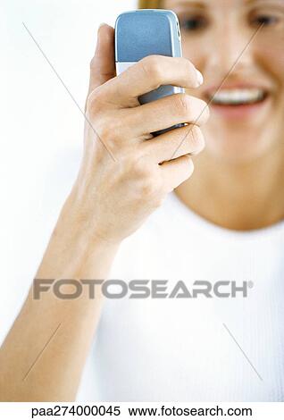 Woman looking at cellphone View Large Photo Image Stock Photography - Woman looking at cellphone. Fotosearch