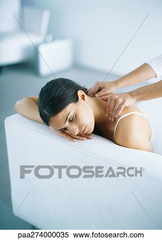 Woman on sofa having shoulders massaged View Large Photo Image Stock Photography - Woman on sofa having shoulders massaged. Fotosearch