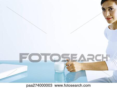 Woman sitting with glass of milk View Large Photo Image Stock Image - Woman sitting with glass of milk. Fotosearch
