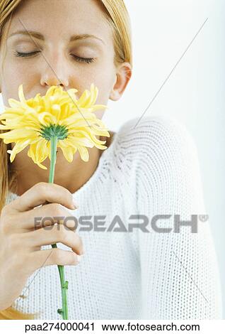 Woman smelling flower with eyes closed View Large Photo Image Stock Image - Woman smelling flower with eyes closed. Fotosearch