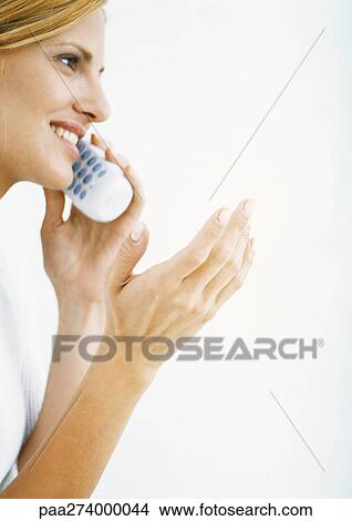 Woman talking on cordless phone and gesturing, side view View Large Photo Image Picture - Woman talking on cordless phone and gesturing, side view. Fotosearch