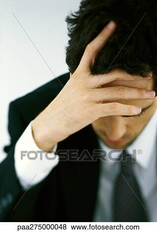 Businessman holding head, high angle view View Large Photo Image Stock Photo - Businessman holding head, high angle view. Fotosearch