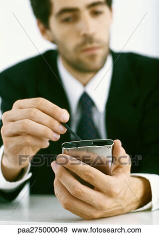 Businessman using electronic organizer View Large Photo Image Stock Photo - Businessman using electronic organizer. Fotosearch
