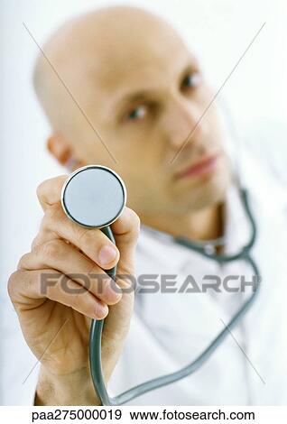 Doctor holding up stethoscope View Large Photo Image Stock Photo - Doctor holding up stethoscope. Fotosearch