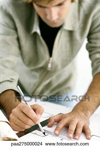 Man drawing on blueprints View Large Photo Image Picture - Man drawing on blueprints. Fotosearch