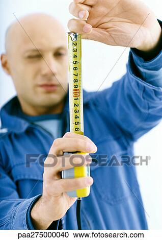 Man holding out measuring tape View Large Photo Image Stock Image - Man holding out measuring tape. Fotosearch