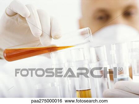 Man transferring contents of test tube View Large Photo Image Stock Photograph - Man transferring contents of test tube. Fotosearch