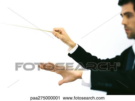 Stock Image - Orchestra conductor, side view. Fotosearch