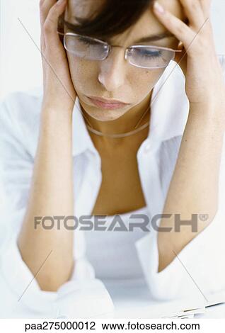 Woman holding head in hands, looking down, high angle view View Large Photo Image Stock Image - Woman holding head in hands, looking down, high angle view. Fotosearch