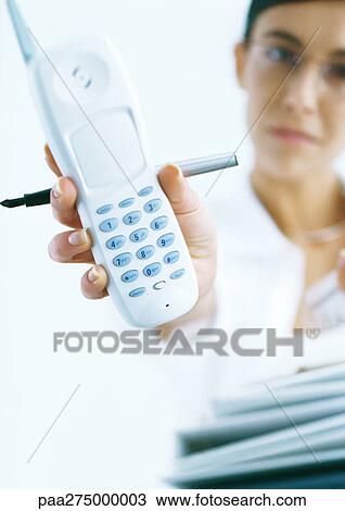 Woman holding out cordless phone View Large Photo Image Stock Image - Woman holding out cordless phone. Fotosearch