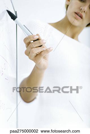 Woman pointing to board with pen, partial view View Large Photo Image Stock Image - Woman pointing to board with pen, partial view. Fotosearch