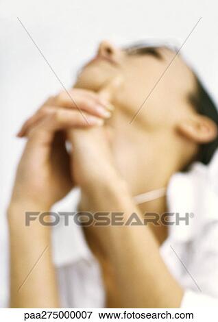 Stock Photo - Woman with hands clasped, low angle view, blurred. Fotosearch