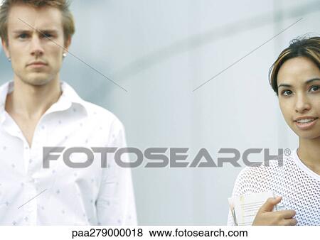 Two young people, looking at camera View Large Photo Image Stock Photo - Two young people, looking at camera. Fotosearch